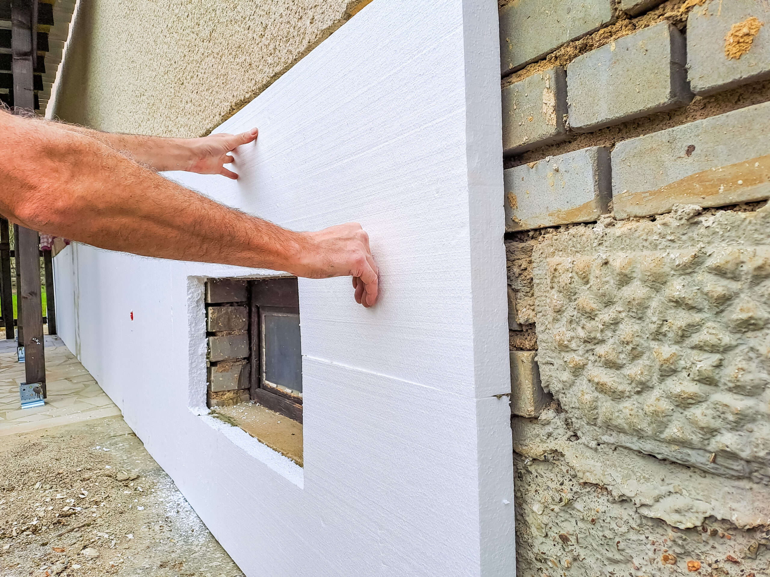 installing rigid styrofoam insulation board for energy saving of the house wall